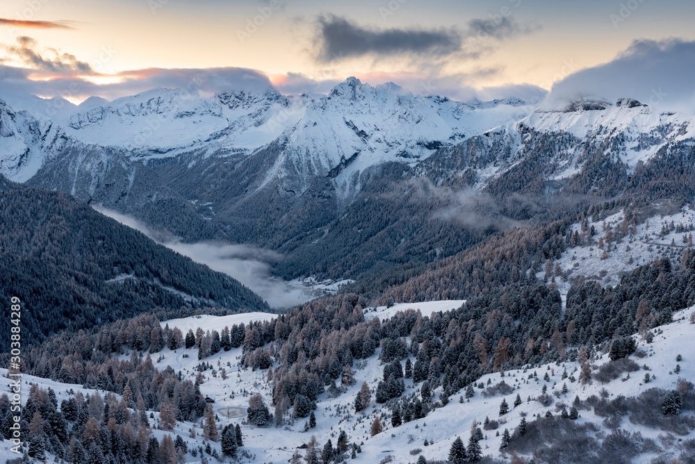 Mountain village in Alpine valley during sunrise / Ski resort village getting ready for winter season