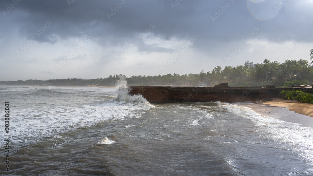 Old ruins of Fort Aguada on the seashores of Goa with sky and clouds during monsoons