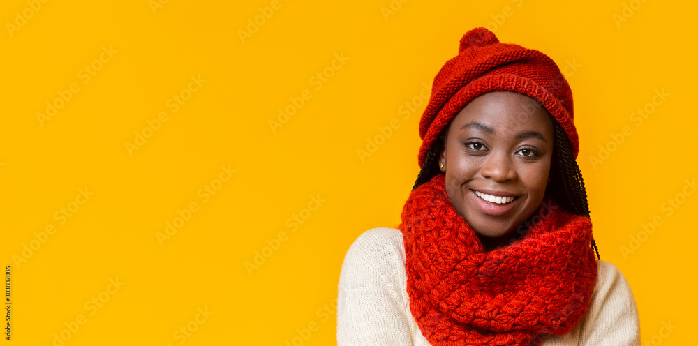 Portrait of cheerful winter african girl over yellow background Portrait of cheerful winter african girl over yellow background