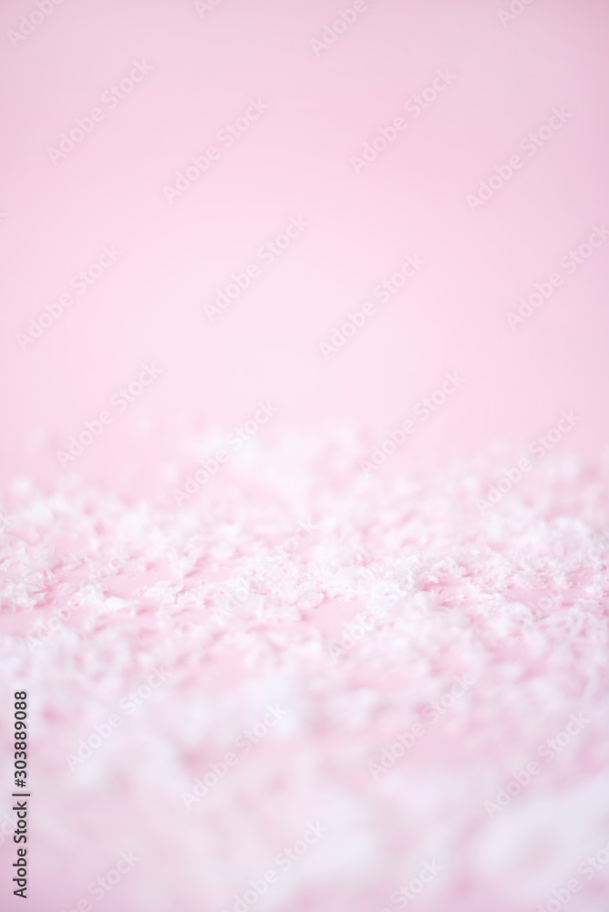 Artificial white snow on a pink background.