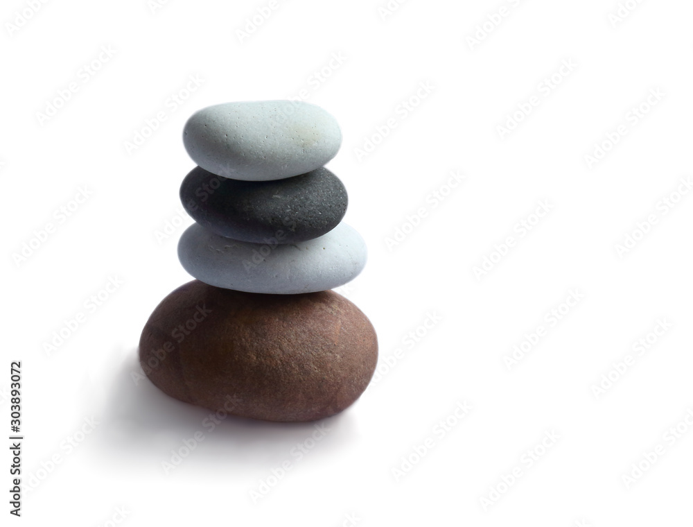 Stacked sea stones pyramids on white background Stacked sea stones pyramids on white background