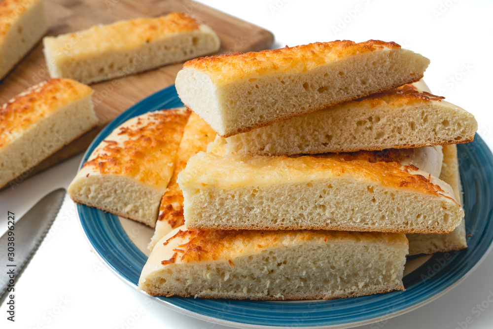 Cheese bread. Homemade delicious  soft cheese bread sticks close up on a plate on white background