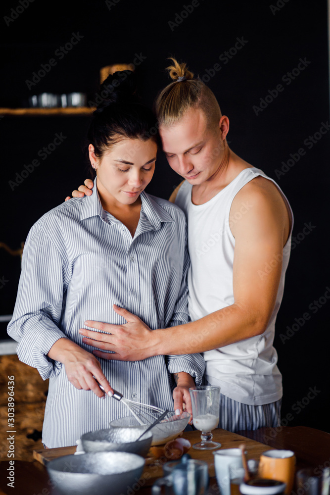 Couple preparing breakfast at home. The girl and the guy live together. Couple preparing breakfast at home. The girl and the guy live together.