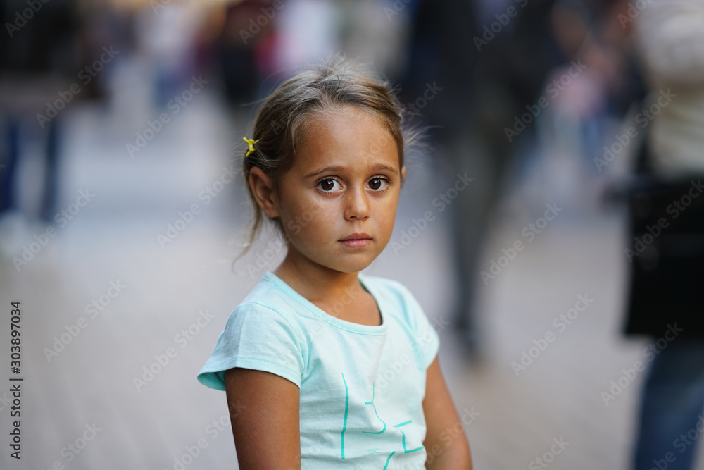 Portrait of 4 year old girl on the blurred background of a shopping street in Sofia