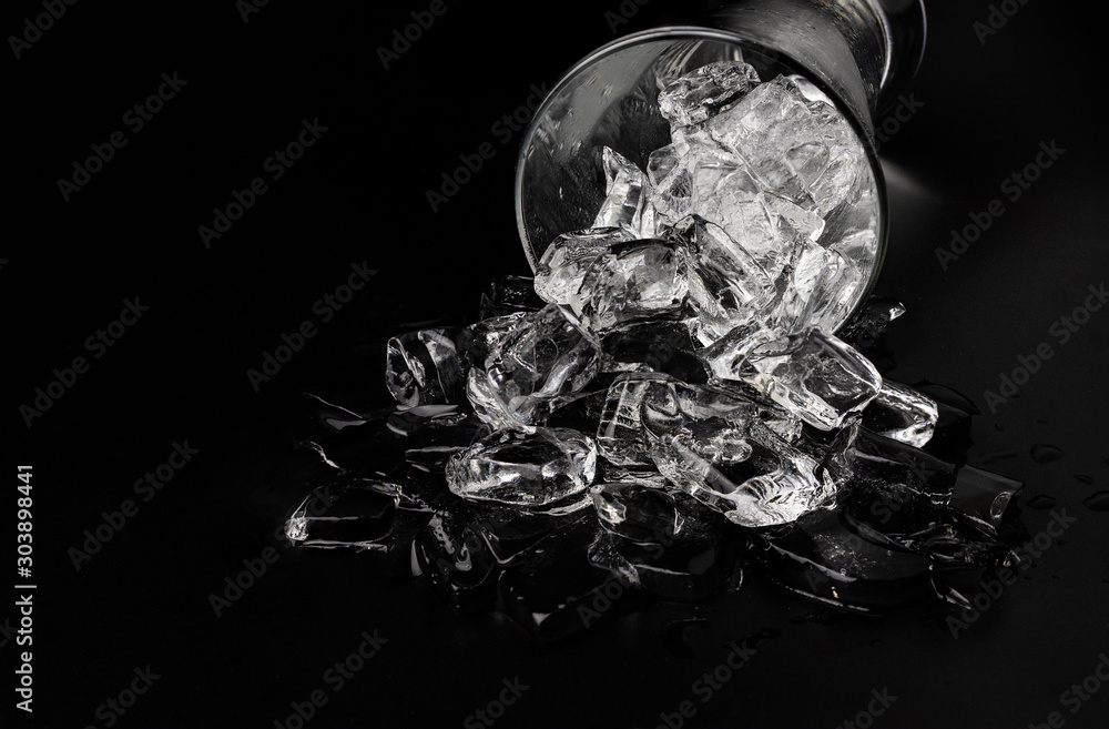 Glass with ice cubes on black background Glass with ice cubes on black background