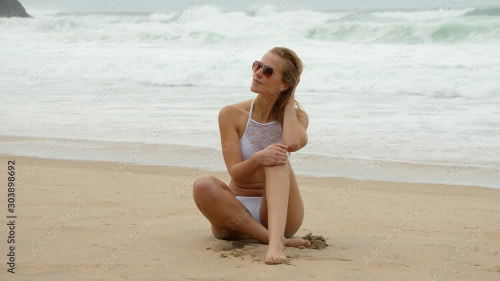 Sexy girl wearing a bikini at the beach - summer vacation at the ocean - travel photography Sexy girl wearing a bikini at the beach - summer vacation at the ocean - travel photography