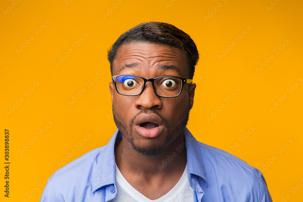 Fototapeta premium Surprised African American Guy Looking At Camera Posing, Yellow Background