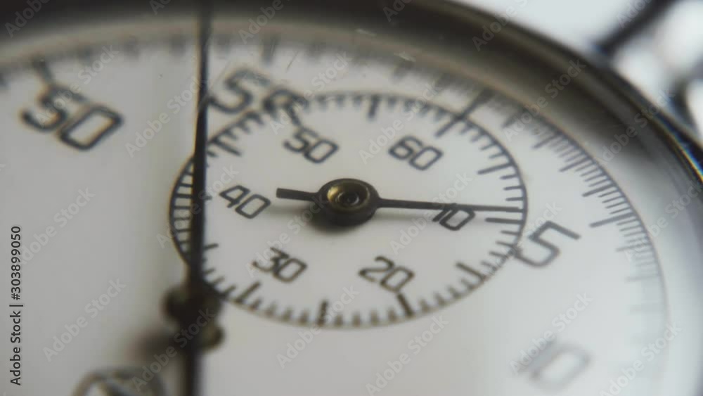 Silver looking chromometer with black numbers and moving arrows put aslant Silver looking chromometer with black numbers and moving arrows put aslant