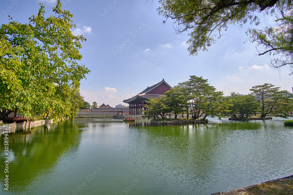 Scenic view of beautiful old building on water in palace in capital of Republic of Korea Seoul. Beautiful summer sunny look of construction in asian style in largest city of South Korea.