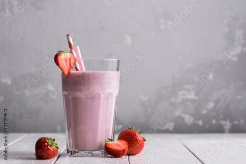 Obraz na płótnie Strawberry protein shake on a white wooden background