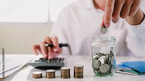 Fotografi asian man working with calculator to calculate numbers