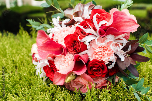 Red bridal bouquet of peonies and roses. Scenery for the wedding. photo