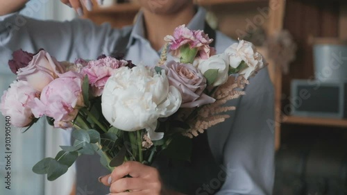 Florist making fresh flower bouquet in flower shop