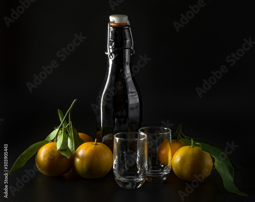 Background with liquor bottle, glasses and tangerines