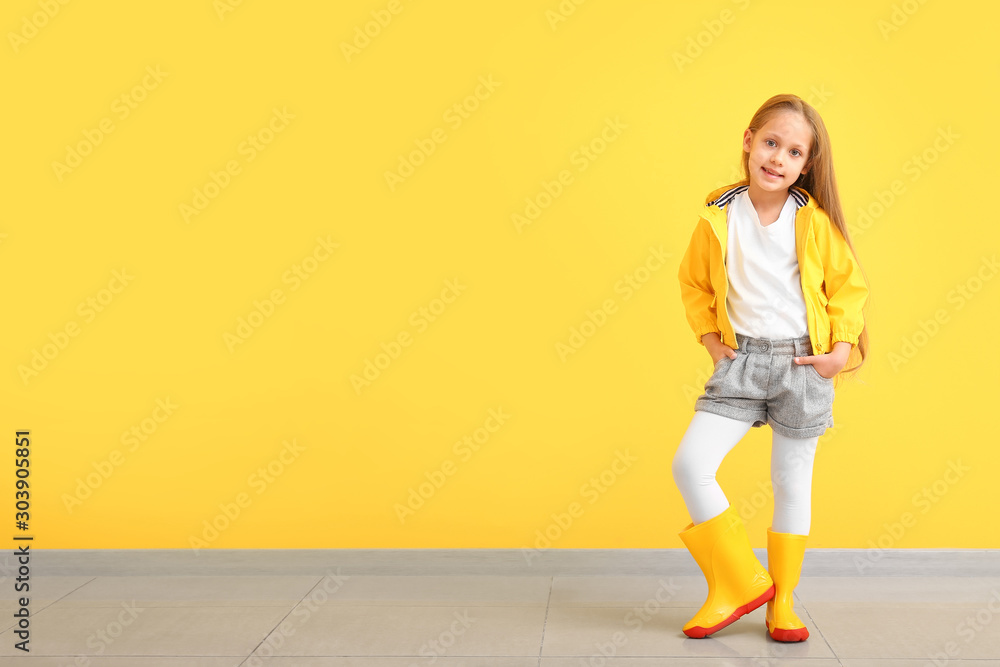Fashionable little girl in autumn clothes near color wall Fashionable little girl in autumn clothes near color wall