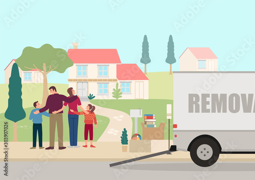 Happy family standing in front of a new house