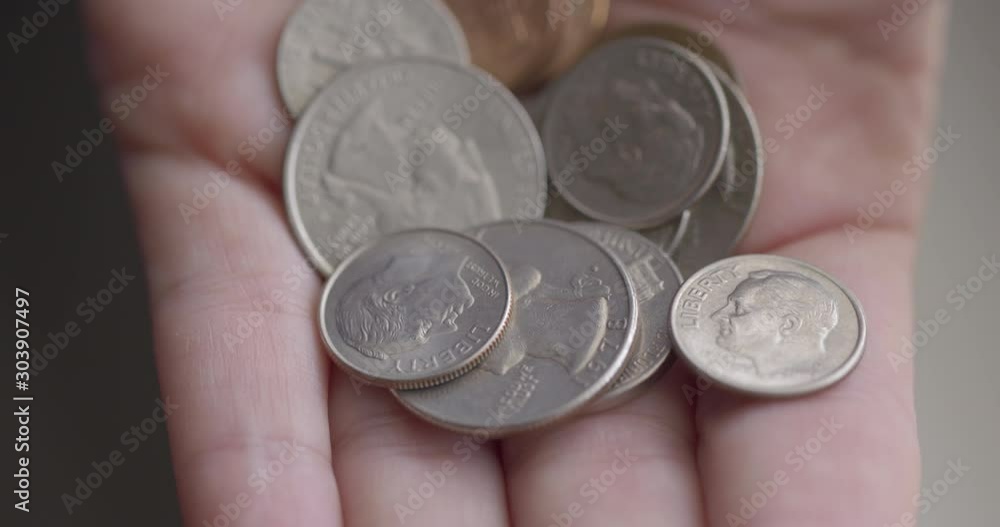 Detail of various United States coins in Caucasian woman's hand. She closes hand around them into fist. Macro close-up with shallow focus and soft daylight, recorded at 60fps 4K Detail of various United States coins in Caucasian woman's hand. She closes hand around them into fist. Macro close-up with shallow focus and soft daylight, recorded at 60fps 4K