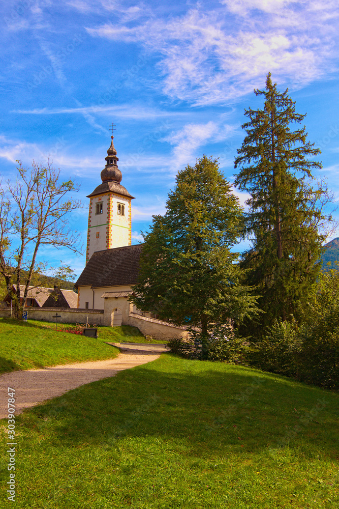 Beautiful landscape photo of Ancient John the Baptist Church near Bohinj lake. Popular travel destination in Slovenia. Triglav National Park, Slovenia Beautiful landscape photo of Ancient John the Baptist Church near Bohinj lake. Popular travel destination in Slovenia. Triglav National Park, Slovenia