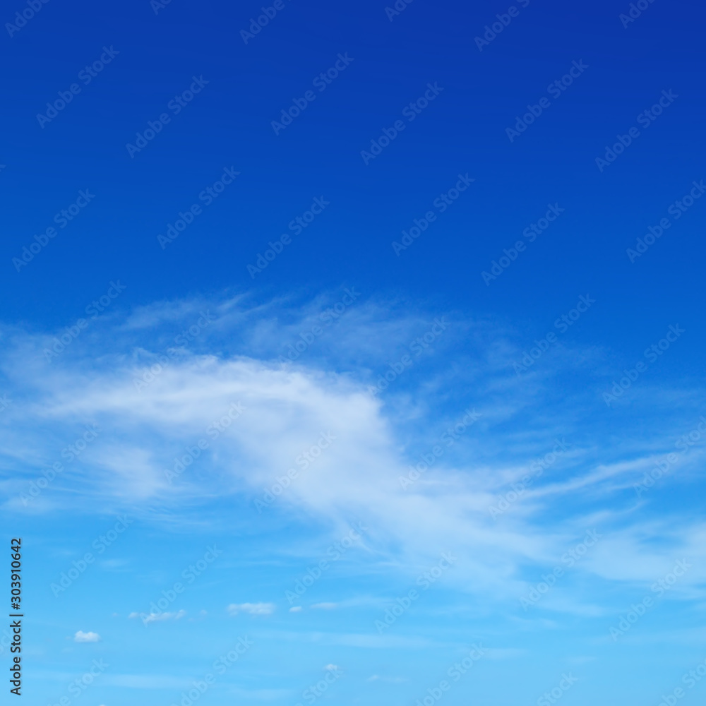Light cirrus clouds in the blue sky . Light cirrus clouds in the blue sky .