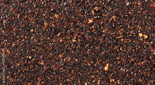Chopped dry chili pepper pile, spicy chopped paprika background and texture