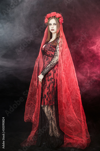 witch vampire girl in red dress with red veil