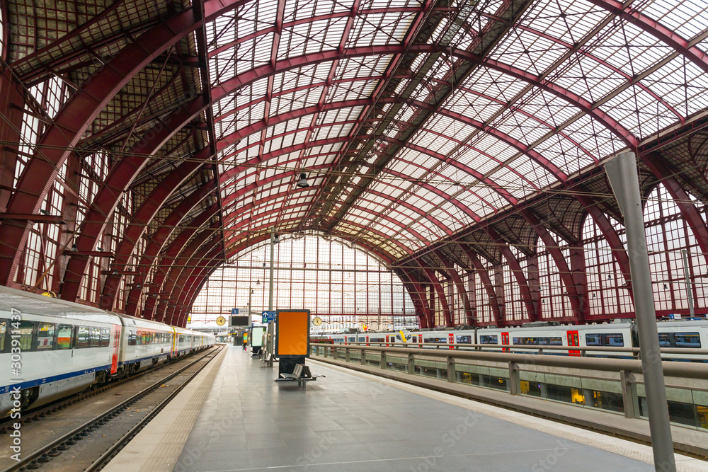 Fototapeta premium Train on railway station platform, Europe