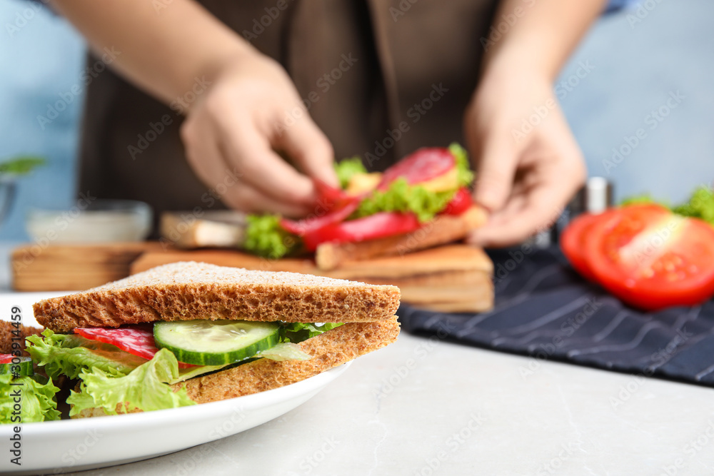 Tasty sandwich on light grey table, closeup