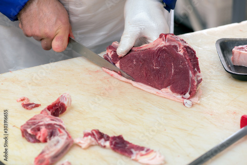cutting meat in the meat shop