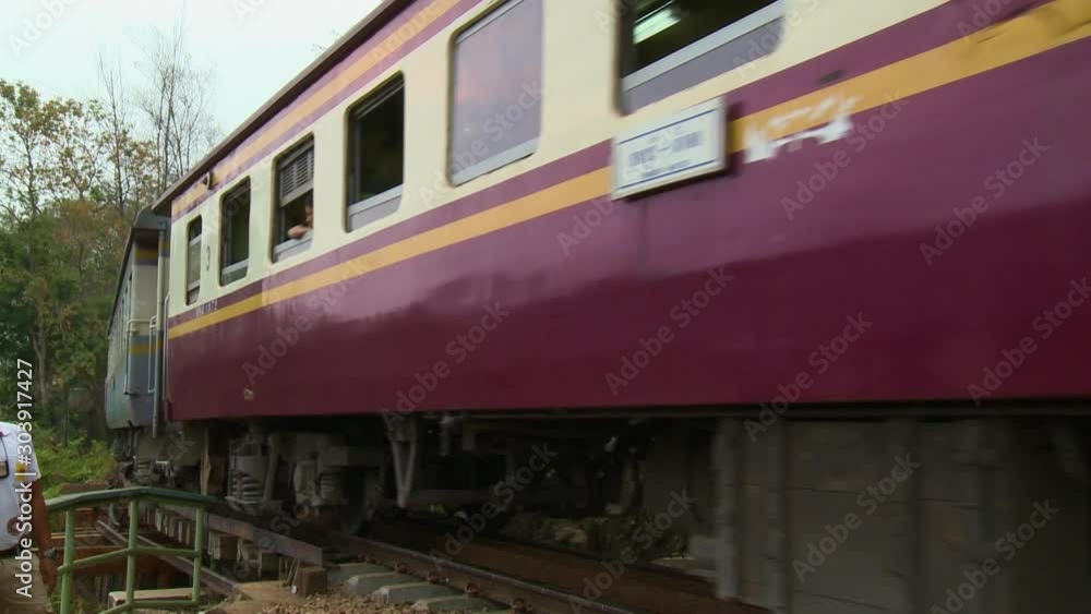 A passenger train moving away from the camera, and going around a bend A passenger train moving away from the camera, and going around a bend