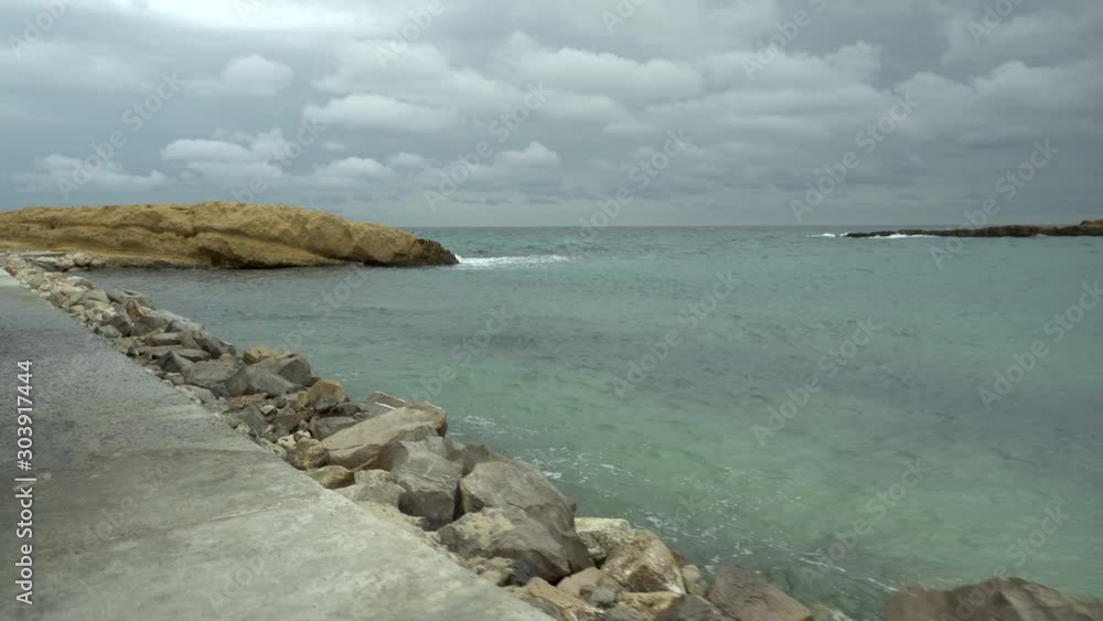 Passage along the road along the rippling sea. Storm on the Mediterranean Sea. Passage along the road along the rippling sea. Storm on the Mediterranean Sea.