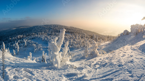 Snowed landscape view from top of hill. Start of ski slope. Everything is frozen.