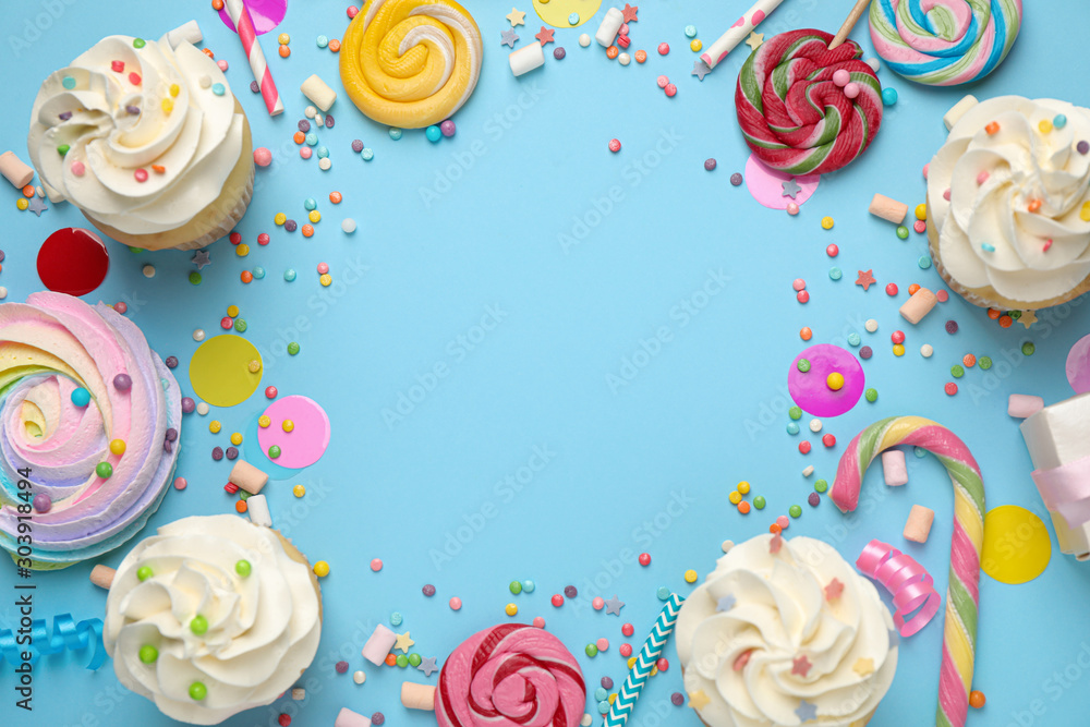 Flat lay composition with cupcakes on light blue background, space for text. Birthday party Flat lay composition with cupcakes on light blue background, space for text. Birthday party
