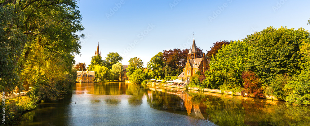 Ancient buildings in park with lake, European town