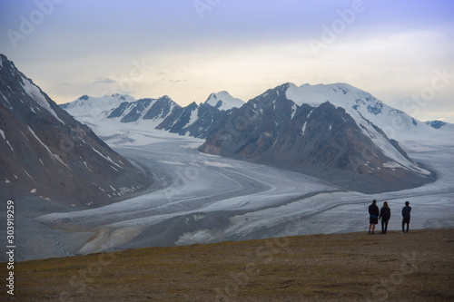 People looking Potanin Glacier in Altai mountains, Mongolia © urdialex