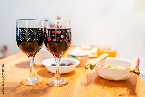Sour foods serving setting on wooden table with rhubarb and cranberry juice or red wine two glasses for miracle berry tasting