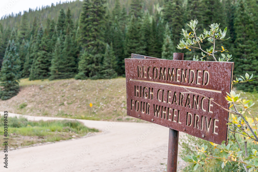 Closeup of high clearance sign on dirt road Ophir pass near Columbine lake trail in Silverton, Colorado in 2019 summer morning
