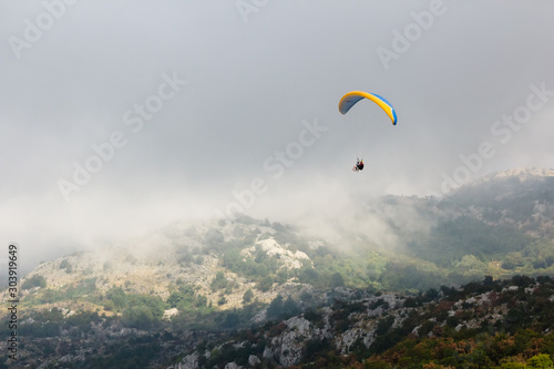 The Paraglide silhouette over mountain peaks. Montenegro.
