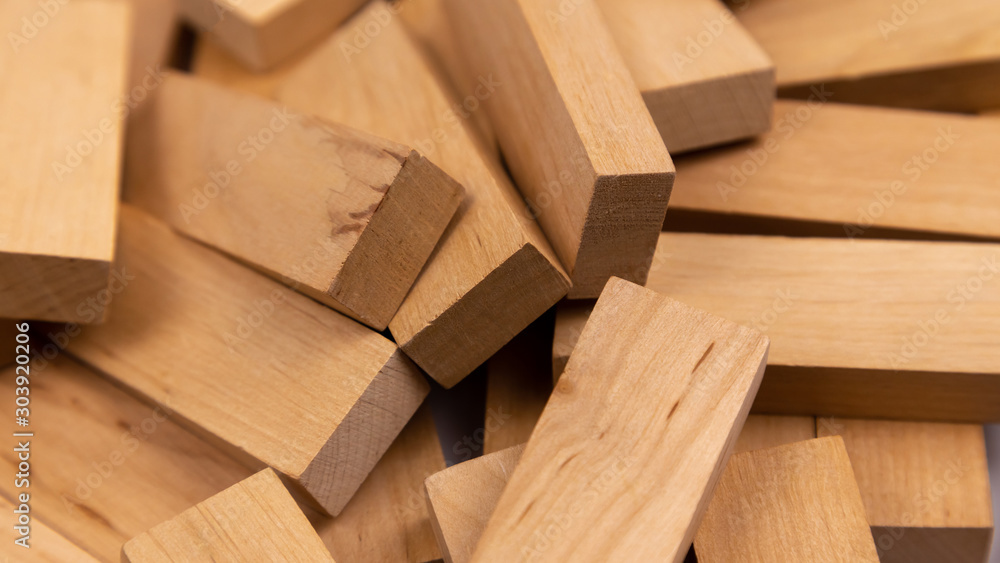 The texture of a pile of wooden blocks that lie randomly. Background. The texture of a pile of wooden blocks that lie randomly. Background.