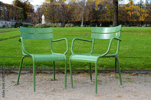 public green chairs in the Tuileries garden in Paris in autumn © Mariia Lomarainen