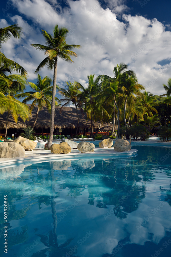 Empty swimming pool and bar with coconut palm trees in Puerto Plata Dominican Republic