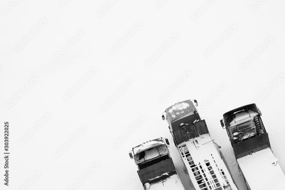 Truck under the snow. lorry covered with snow after snowfall. long trucks stand in a row aerial view. transportation concept. snow covered vehicles. copy space Truck under the snow. lorry covered with snow after snowfall. long trucks stand in a row aerial view. transportation concept. snow covered vehicles. copy space