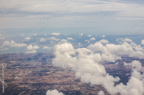 View from the porthole of an airplane. Clouds over Lisbon.