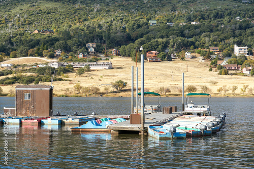 Small pier with little boat at Lake Cuyamaca, 110 acres reservoir and a recreation area in the eastern Cuyamaca Mountains, located in eastern San Diego County, California, USA photo