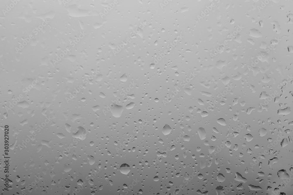 Water drops on light background, closeup view Water drops on light background, closeup view