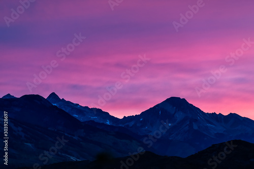 Aspen  Colorado colorful purple pink blue vivid vibrant sunset twilight with Snowmass mountain peak ridge closeup silhouette
