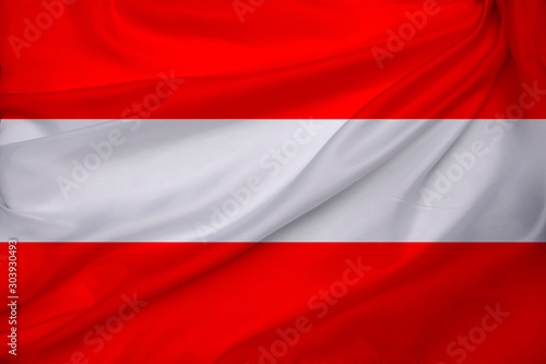 photograph of the beautiful colored national flag of the modern state of Austria on textured fabric, concept of tourism, economics and politics, close-up