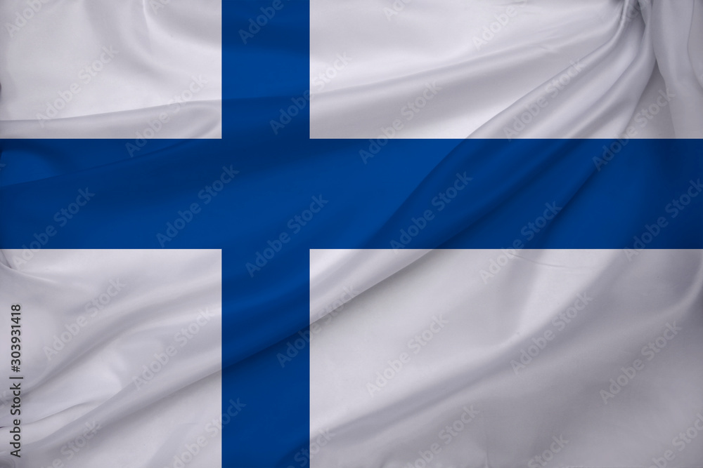 Fototapeta premium beautiful colored national flag of the state of Finland on textural fabric, concept of tourism, economy and politics, closeup