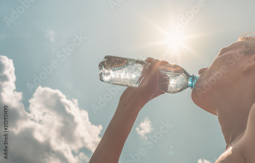 Female portrait drinking bottle water.  photo