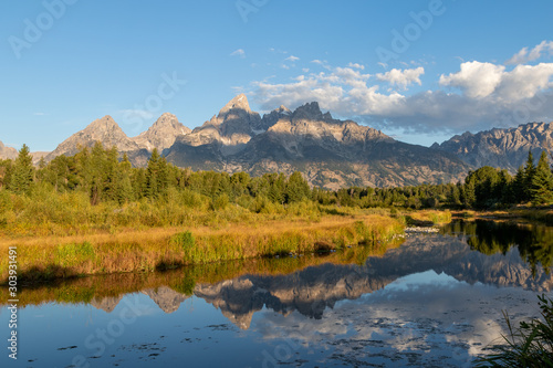 A view of the Grand Teton mountains at sunrise with a reflection in the Snake river from Schwabacher © Louis