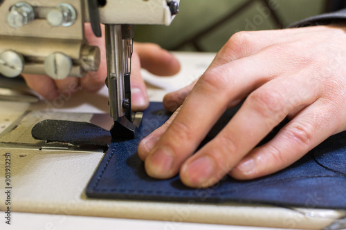 professional production sewing machine close-up, leather production, hand seamstress, hand tailor